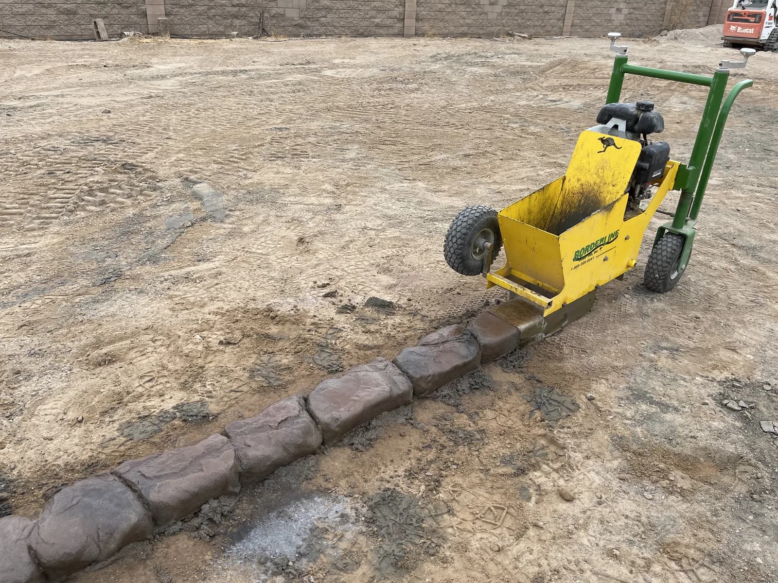 A back yard cut back to bare dirt with a sod cutter, ready for a rebuild
